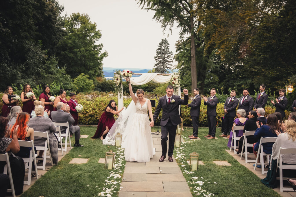 Bride and Groom celebrate Walking down the aisle in Westchester County Wedding. Hudson valley Planning by venue 