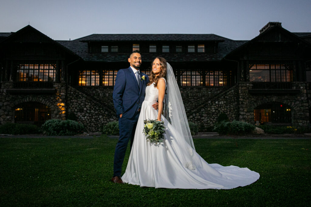 Bride and Groom pose on the lawn ofBear Mountain Inn, Hudson Valley Wedding Planning