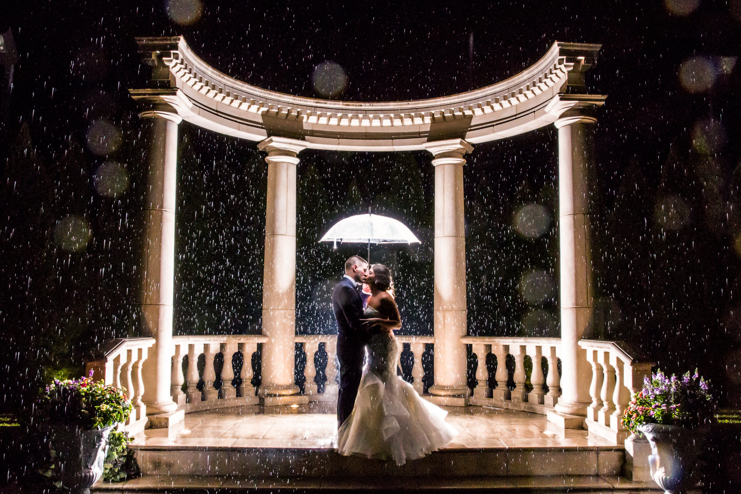 Bride and Groom kissing in the rain.