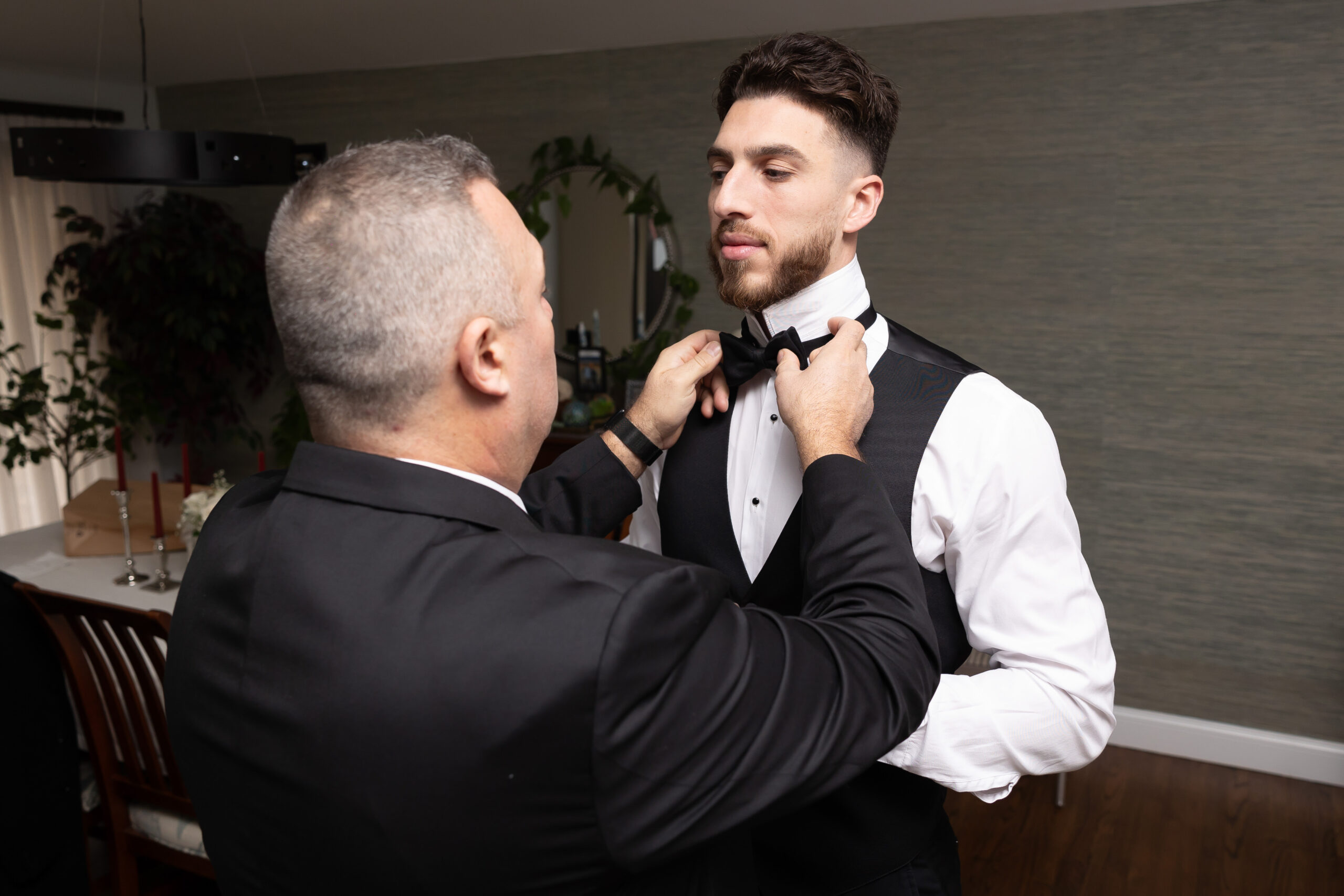 Groom having his bowtie fixed on wedding day photo shot list
